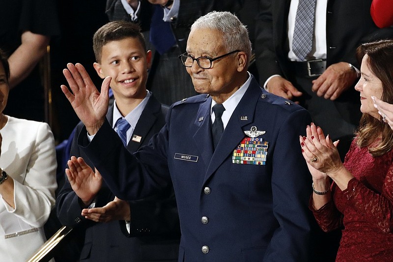 FILE - Tuskegee airman Charles McGee and his great grandson Iain Lanphier react as President Donald Trump delivers his State of the Union address to a joint session of Congress on Capitol Hill in Washington, Tuesday, Feb. 4, 2020. McGee, one of the last surviving Tuskegee Airmen who flew 409 fighter combat missions over three wars, died Sunday, Jan. 16, 2022. He was 102. (AP Photo/Patrick Semansky, File)

