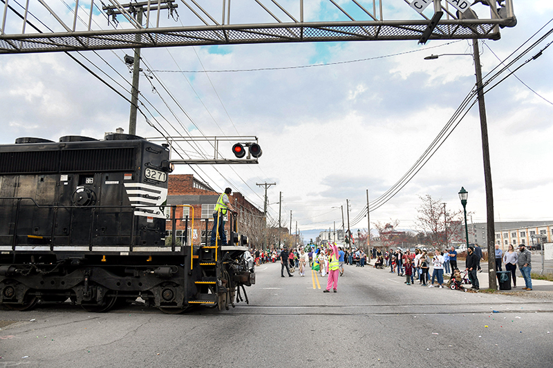 Photo by Mark Gilliland / A train crosses Main Street, temporarily interrupting the parade.