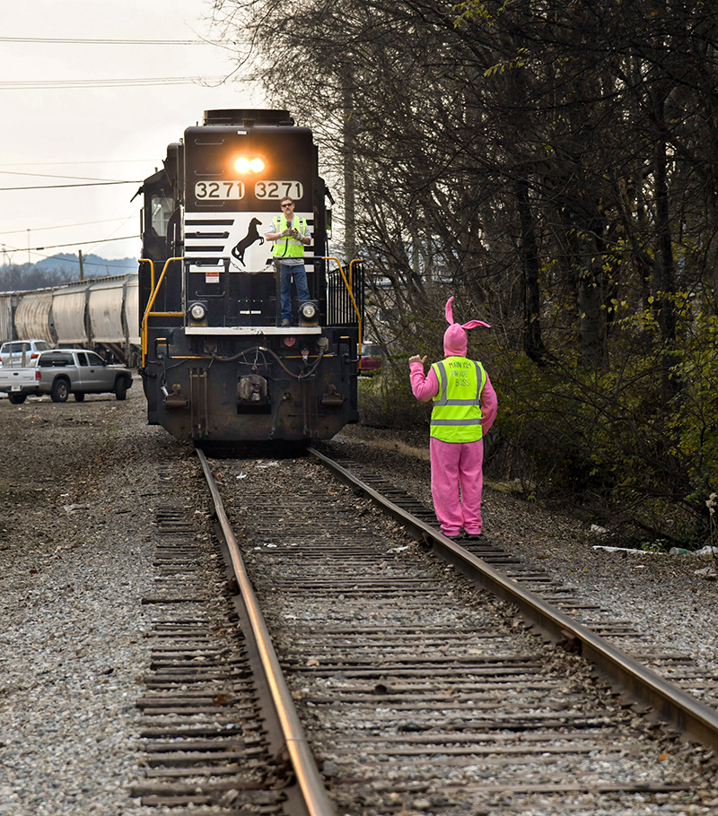 Photo by Mark Gilliland / Parade boss Michael Walker works with an oncoming train.