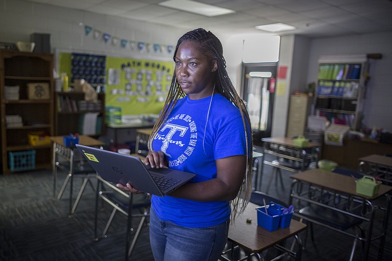 AP Photo/Stephen B. Morton / Johnson County Middle School teacher Shaunteria Russell teaches her seventh-grade students math from an empty classroom because of mounting coronavirus numbers last August in Wrightsville, Ga.
