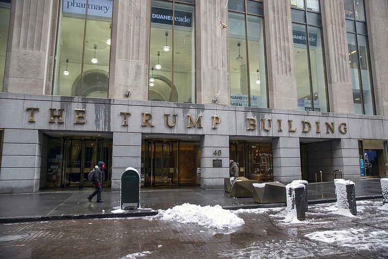 Photo by Ted Shaffrey of The Associated Press / People walk by The Trump Building office building at 40 Wall Street in New York City on Jan. 7, 2022.