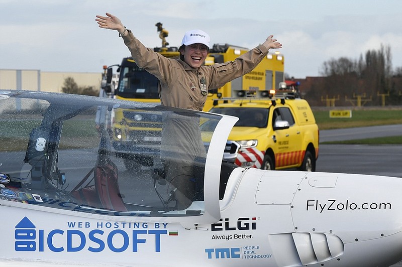 Belgium-British teenage pilot Zara Rutherford jubilates in the cockpit after landing her Shark ultralight plane at the Kortrijk airport in Kortrijk, Belgium, Thursday, Jan. 20, 2022. The 19-year-old Belgium-British pilot Zara Rutherford has set a world record as the youngest woman to fly solo around the world, touching her small airplane down in western Belgium on Thursday, 155 days after she departed. Rutherford will find herself in the Guinness World Records book after setting the mark that had been held by 30-year-old American aviator Shaesta Waiz since 2017. (AP Photo/Geert Vanden Wijngaert)