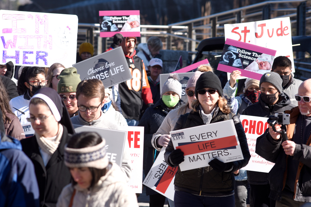 Staff Photo by Robin Rudd / Marchers hold signs as they turn west after crossing the Walnut Street Bridge during Saturday's March for Life in Chattanooga.