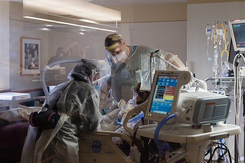 File photo by Ariana Drehsler of The New York Times / Nurses treat a COVID-19 patient in the intensive care unit at Sharp Chula Vista Medical Center in San Diego on Dec. 10, 2020.