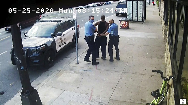 This image from video shows Minneapolis police Officers Thomas Lane, left and J. Alexander Kueng, right, escorting George Floyd, center, to a police vehicle outside Cup Foods in Minneapolis, on May 25, 2020. Three former Minneapolis officers headed to trial this week on federal civil rights charges in the death of George Floyd aren't as familiar to most people as Derek Chauvin, a fellow officer who was convicted of murder last spring. (Court TV via AP, Pool, File)