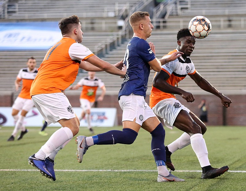 Staff photo by Erin O. Smith / 
Inter Nashville FC's Roy King, on the left, and Lyndsey Moreland, on the right, fight with CFC's Mason Walsh for possession of the ball during the CFC vs. Inter Nashville FC soccer game Friday, July 12, 2019 at Finley Stadium in Chattanooga, Tennessee.