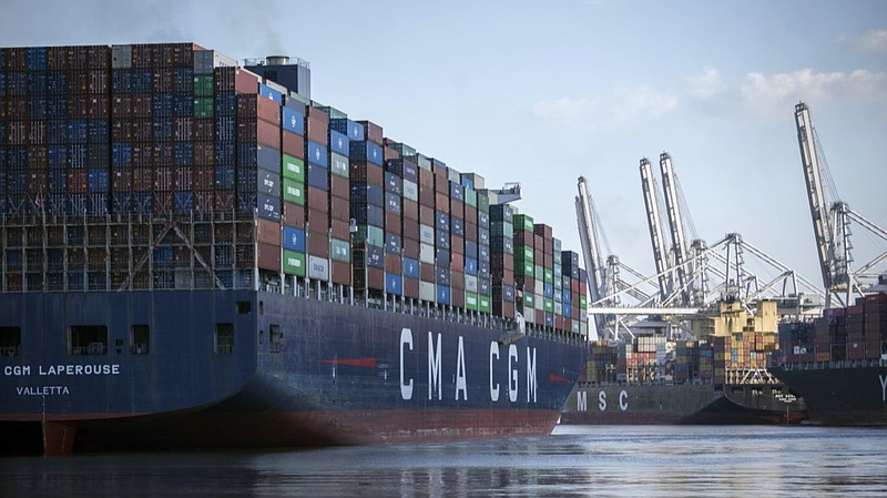 The container ship CMA CGM Laperouse, left, docks at the Georgia Ports Authority's Port of Savannah, Sept. 29, 2021, in Savannah, Ga. The Port of Savannah saw a whopping 20% increase in shipping containers moving across its docks in 2021 as U.S. seaports scrambled to keep up with a surge in cargo that crammed container yards and forced ships to line up and wait at sea. The Georgia Ports Authority reported Tuesday, Jan. 25, 2022 that Savannah's port handled a record 5.6 million container units of imports and exports last year an increase of 1 million container units from the 2020 calendar year. (AP Photo/Stephen B. Morton, file)