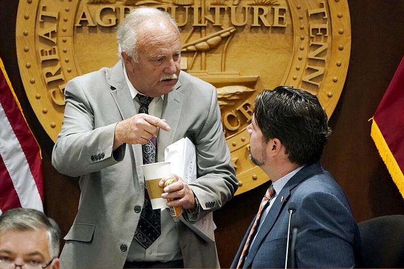 Rep. Bud Hulsey, R-Kingsport, left, talks with Rep. Andrew Farmer, R-Sevierville, before a meeting of the COVID-19 Committee, Oct. 28, 2021, in Nashville, Tenn. The first month back at the state Capitol has felt frustratingly familiar for Black lawmakers in Tennessee's majority-white Legislature. First, lawmakers passed a new congressional map scattering Nashville's Black voters across multiple districts. Now, Hulsey wants to advance a resolution dismissing the existence of deep-rooted racism in the military as detailed in an Associated Press investigation. (AP Photo/Mark Humphrey, FILE)