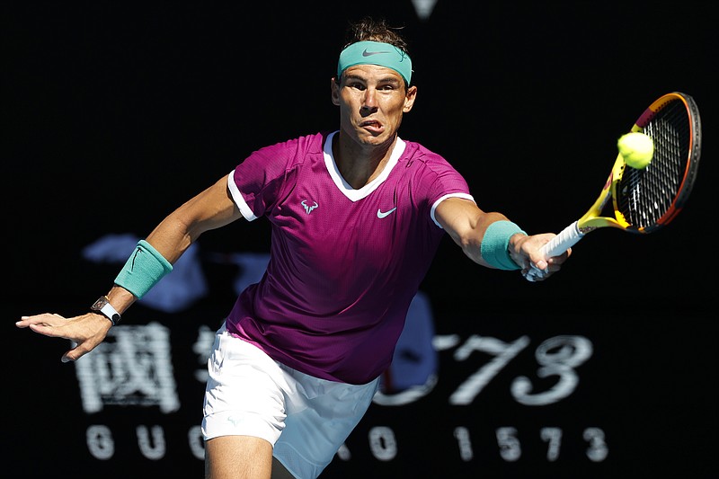 Rafael Nadal of Spain plays a forehand return to Denis Shapovalov of Canada during their quarterfinal match at the Australian Open tennis championships in Melbourne, Australia, Tuesday, Jan. 25, 2022. (AP Photo/Tertius Pickard)