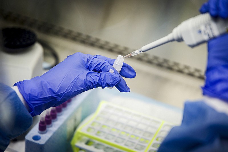 A laboratory technician prepares COVID-19 patient samples for semi-automatic testing at Northwell Health Labs, March 11, 2020, in Lake Success, N.Y. Republicans' faith in science is falling as Democrats rely on it even more with a trust gap in science and medicine widening substantially during the COVID-19 pandemic, new survey data shows. It's the largest gap in nearly five decades of polling by the General Social Survey, a widely respected trend survey conducted by NORC at the University of Chicago that has been measuring confidence in institutions since 1972. (AP Photo/John Minchillo, File)