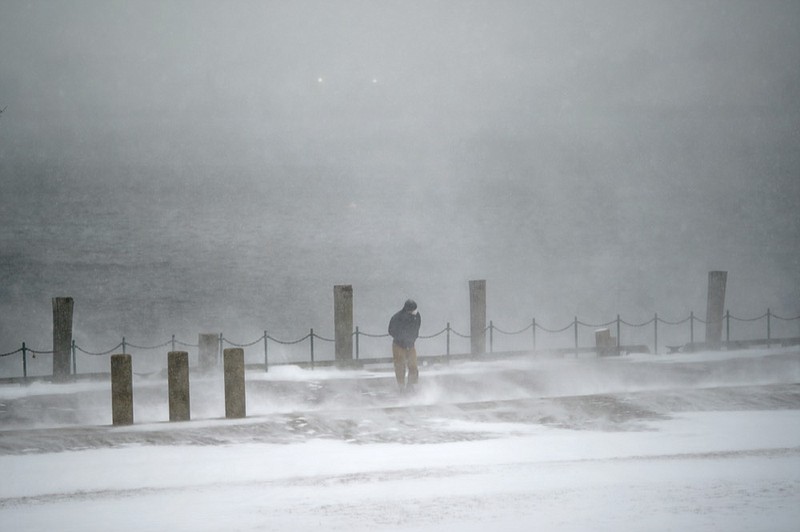 A pedestrian walks through a gust of wind along the waterfront in India Point Park in Providence, R.I., Saturday, Jan. 29, 2022. (AP Photo/David Goldman)

