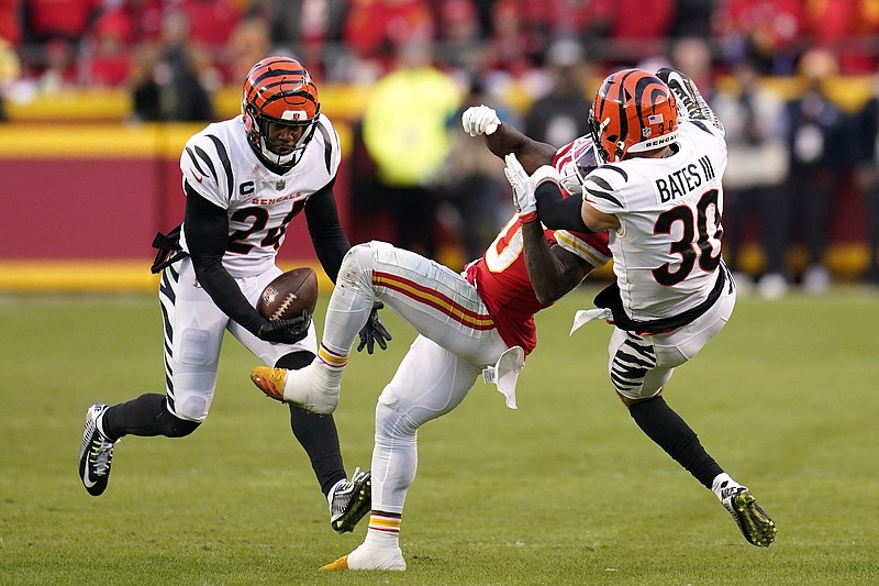 AP photo by Paul Sancya / Cincinnati Bengals safety Vonn Bell intercepts a pass intended for Kansas City Chiefs wide receiver Tyreek Hill, center, as Bengals free safety Jessie Bates defends during overtime of Sunday's AFC title game.