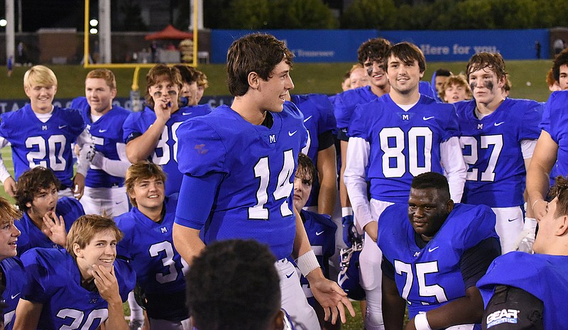 Staff photo by Matt Hamilton / McCallie quarterback William Riddle (14) talks to his teammates after their win against Baylor in October 2020. Riddle took over the starting job four games into that season as a junior and helped lead the Blue Tornado to their second straight state title. This past fall, he helped the program to a third TSSAA Division II-AAA championship in a row to cap an undefeated season.