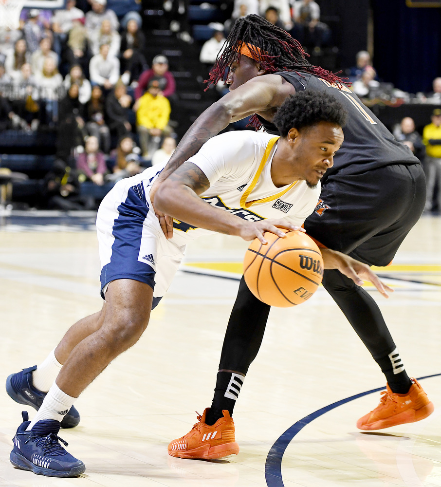 Staff Photo by Robin Rudd / UTC's Tada Stricklen (4) drives under the arm of a Bear defender, being fouled on the play. The University of Tennessee at Chattanooga Mocs hosted the Mercer Bears in Southern Conference basketball, at McKenzie Arena, on February 5, 2022.