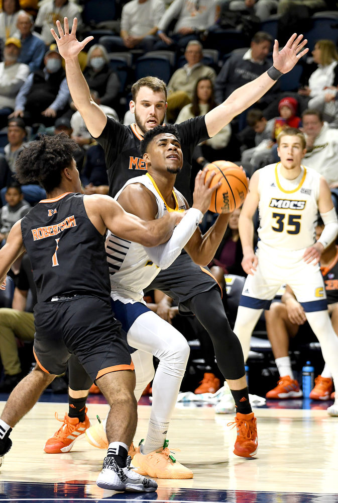 Staff Photo by Robin Rudd / UTC's Malachi Smith (13) looks to shoot, but is fouled by Mercer's Kamar Robertson (1). The University of Tennessee at Chattanooga Mocs hosted the Mercer Bears in Southern Conference basketball, at McKenzie Arena, on February 5, 2022.