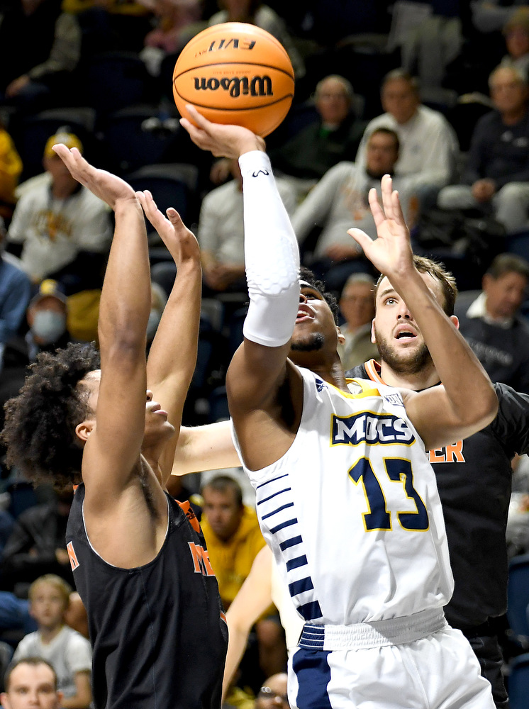 Staff Photo by Robin Rudd / UTC's Malachi Smith (13) scores form underneath the basket. head coach Lamont Paris directs the Moc defense. The University of Tennessee at Chattanooga Mocs hosted the Mercer Bears in Southern Conference basketball, at McKenzie Arena, on February 5, 2022.