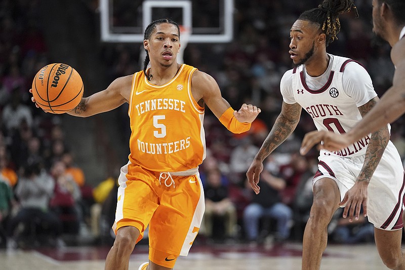 AP photo by Sean Rayford / Tennessee guard Zakai Zeigler dribbles past South Carolina's James Reese V during the second half of Saturday's game in Columbia, S.C. Zeigler overcame an upset stomach to score 18 points and help the No. 22 Vols win 81-57.