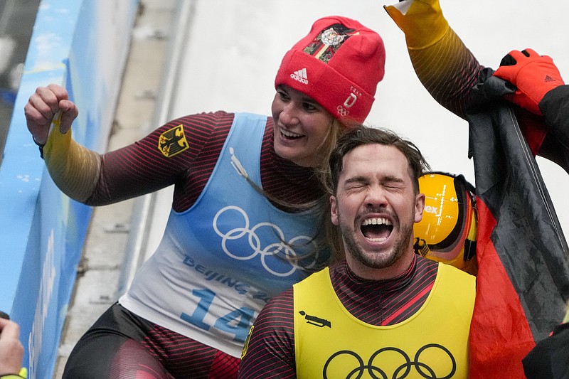 Photo by Mark Schiefelbein of The Associated Press / Natalie Geisenberger and Tobias Wendl, of Germany, celebrate winning the gold medal in luge team relay at the 2022 Winter Olympics on Thursday, Feb. 10, 2022, in the Yanqing district of Beijing.