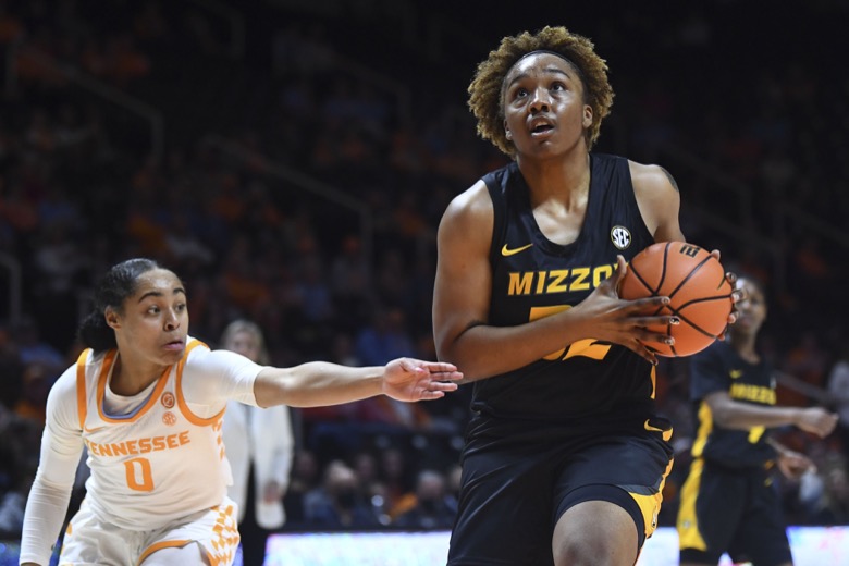 Missouri center Jayla Kelly (32) drives to the basket past Tennessee guard Brooklynn Miles (0) during an NCAA college basketball game, Thursday, Feb. 10, 2022 in Knoxville, Tenn.(Saul Young/Knoxville News Sentinel via AP)