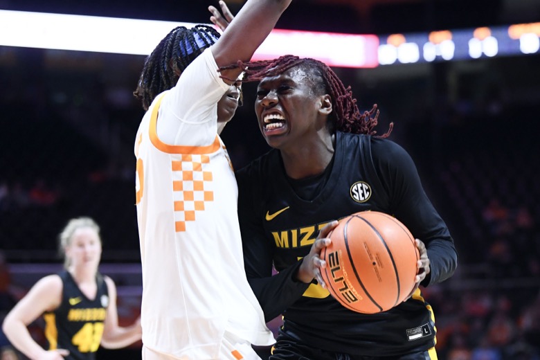 Missouri guard Aijha Blackwell (33) tries to get to the basket while guarded by Tennessee guard Jordan Horston (25) during an NCAA college basketball game, Thursday, Feb. 10, 2022 in Knoxville, Tenn.(Saul Young/Knoxville News Sentinel via AP)