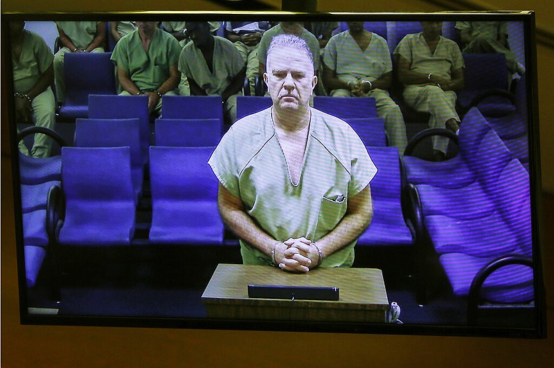Jorge Carballo makes an initial appearance in Broward County court via video teleconference, Tuesday, Aug. 29, 2019, in Fort Lauderdale, Fla. Carballo, an administrator, was charged with multiple counts of aggravated manslaughter for the 2017 heat-related deaths of 12 patients after Hurricane Irma knocked out the facility's air conditioning. Charges were also filed against nurse Althia Meggie, and nurse supervisor Sergo Colin. (AP Photo/Ellis Rua)