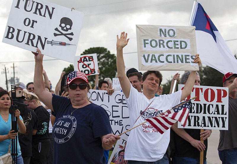  In this June 7, 2021, photo, demonstrators at Houston Methodist Baytown Hospital in Baytown, Texas, wave at cars that honk at them to support their protest against a policy that says hospital employees must get vaccinated against COVID-19 or lose their jobs. Religious exemptions are increasingly becoming a workaround for hospital and nursing home staff who want to keep their jobs in the face of federal COVID-19 vaccine mandates that are going into effect nationwide this week. (Yi-Chin Lee/Houston Chronicle via AP, File)