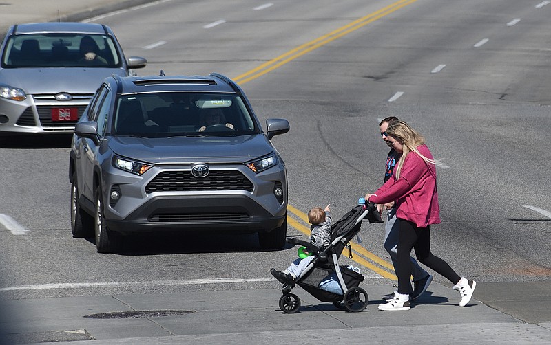 Staff Photo by Matt Hamilton / Pedestrians cross Market Street near the Chief John Ross Bridge on Tuesday, February 15, 2022.