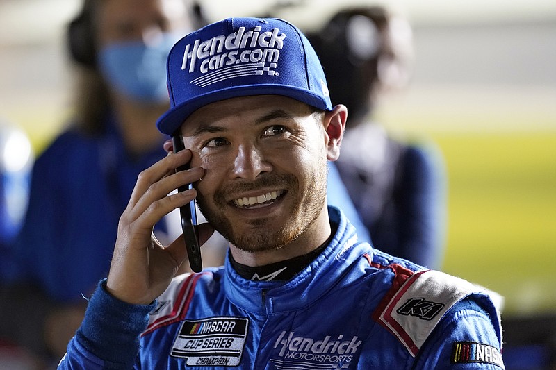 AP photo by Chris O'Meara / Hendrick Motorsports driver Kyle Larson smiles as he talks on the phone Wednesday night at Daytona International Speedway after his qualifying run for Sunday's Daytona 500, the season opener for the NASCAR Cup Series. Larson, the reigning series champion, won the pole position.