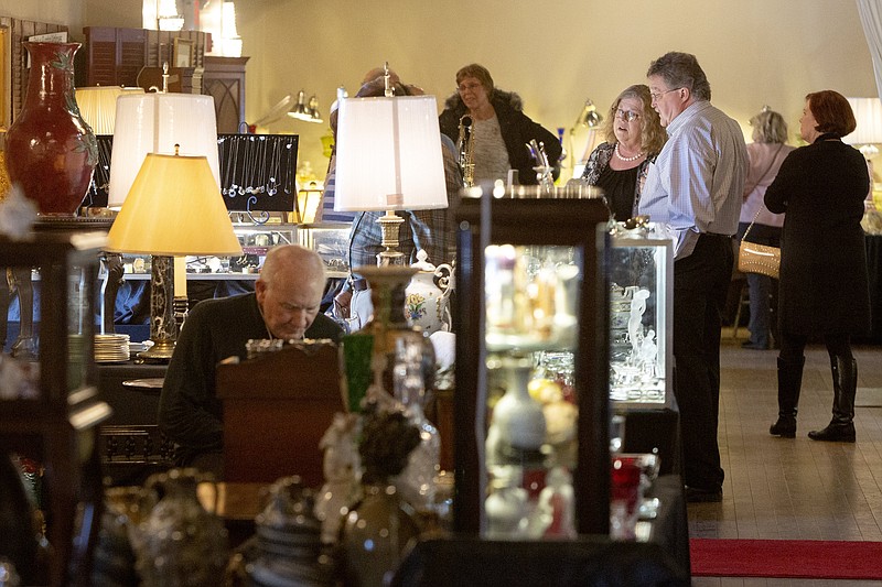 Staff file photo / Patrons mingle during a previous Houston Museum Antiques Show & Sale. This year, for the first time, the three-day show moves to the Read House. A preview party on Feb. 24 gives early shoppers dibs on the merchandise.