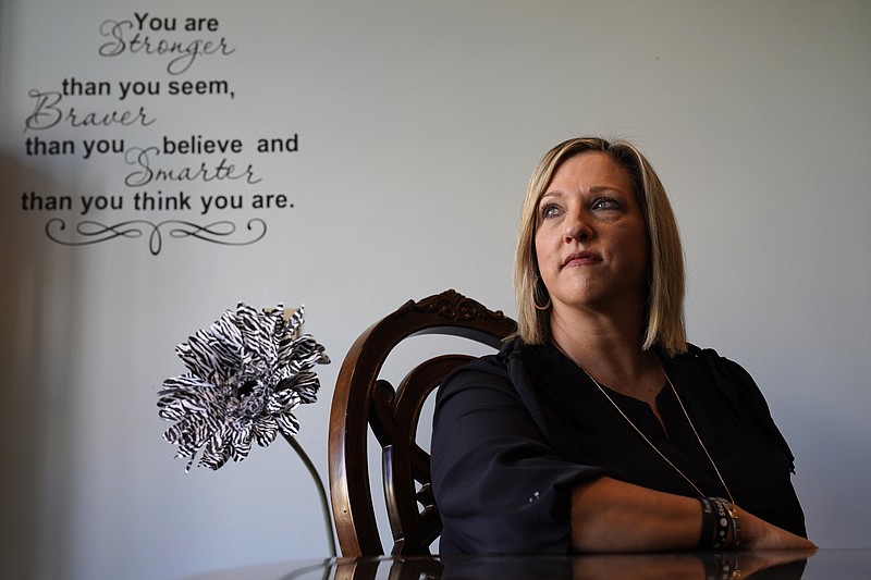 Tina Meier, founder of the Megan Meier Foundation, poses for a photo in the foundation's office Wednesday, Dec. 8, 2021, in St. Charles, Mo. Meier's daughter, Megan, committed suicide in 2007 at the age of 13 after being harassed by a "friend" on MySpace who later turned out to be the mother of a classmate who was using the fake account to bully the unsuspecting teen. (AP Photo/Jeff Roberson)