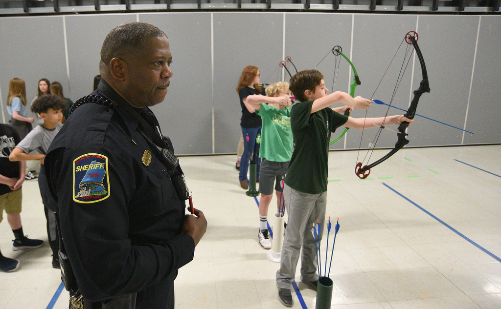 Staff Photo by Matt Hamilton / School resource officer Mike Houston watches his students during archery practice at Lofts Middle School in Hixson on Thursday, February 17, 2022.