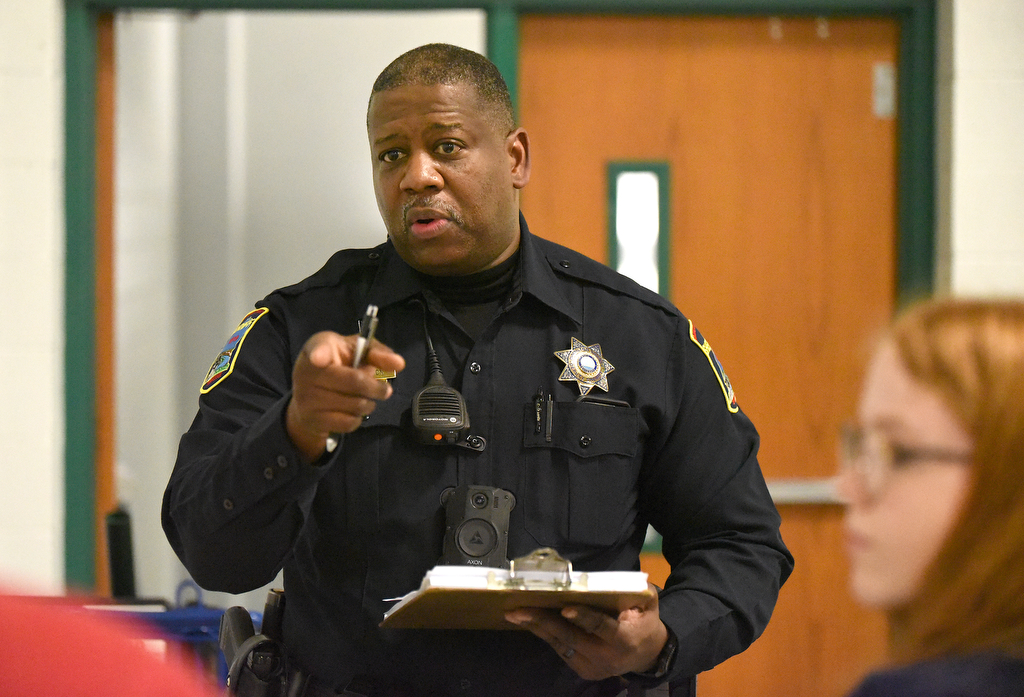 Staff Photo by Matt Hamilton / School resource officer Mike Houston talks to students about their times to compete in an upcoming archery tournament at Loftis Middle School in Hixson on Thursday, Feb. 17, 2022.