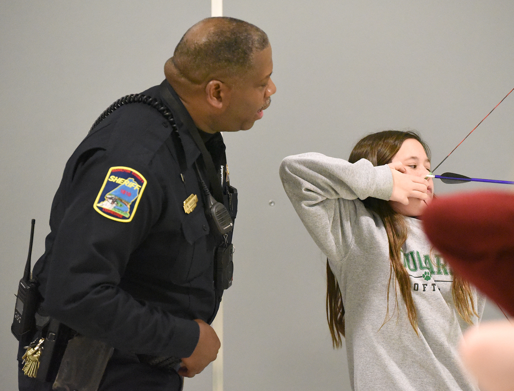 Staff Photo by Matt Hamilton / School resource officer Mike Houston watches Sadie Campbell, 12, as she practices archery at Lofts Middle School in Hixson on Thursday, February 17, 2022.