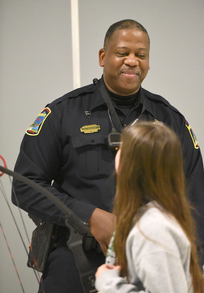 Staff Photo by Matt Hamilton / School resource officer Mike Houston talks to Sadie Campbell, 12, about archery at Loftis Middle School in Hixson on Thursday, Feb. 17, 2022.