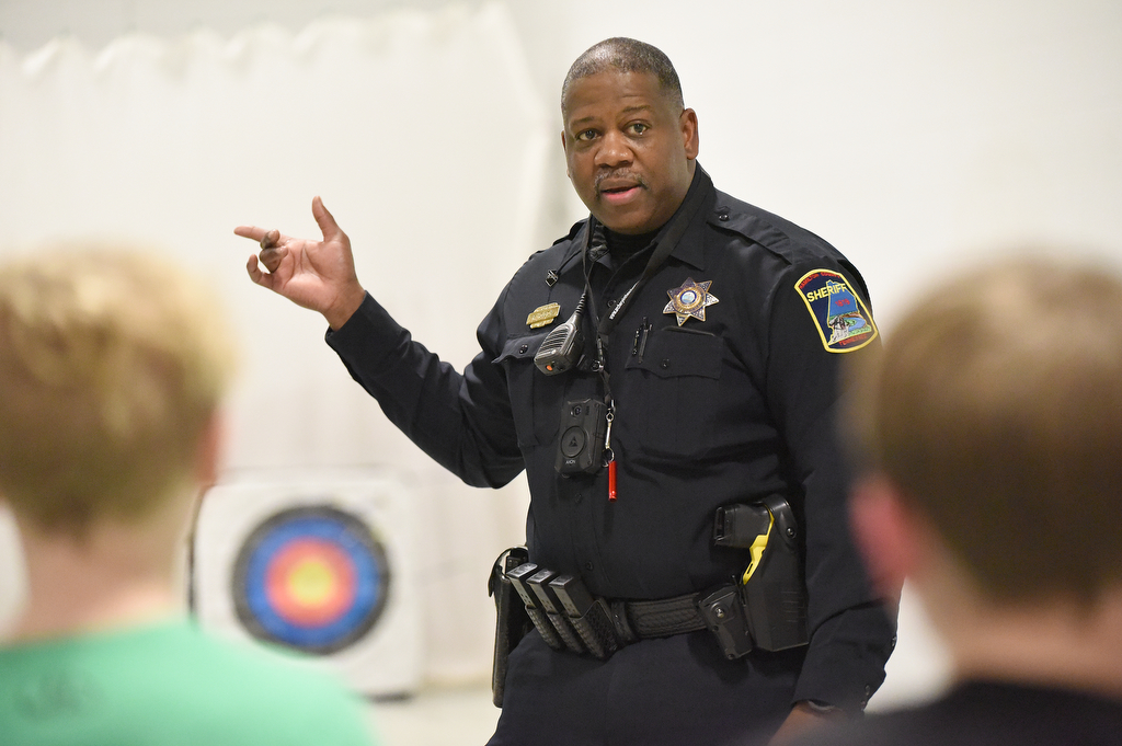 Staff Photo by Matt Hamilton / School resource officer Mike Houston talks to students about an upcoming competition as he teaches archery at Loftis Middle School in Hixson on Thursday, Feb. 17, 2022.