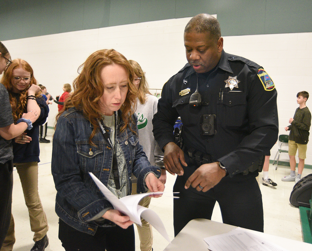 Staff Photo by Matt Hamilton / School resource officer Mike Houston talks to Erin Smith who also coaches archery at Loftis Middle School in Hixson on Thursday, Feb. 17, 2022.