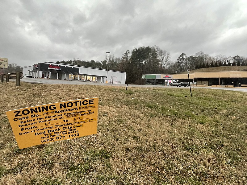 Photo by Dave Flessner / Planning commission sign shows site of the Sav A lot shopping center the city is being asked to rezone to a C-3 commercial neighborhood zone to allow townhomes along with commercial development on the site.