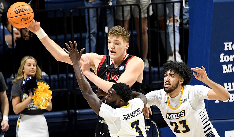 Staff Photo by Robin Rudd / VMI's Jake Stephens (34) passes out of the defense of UTC's David Jean-Baptiste (3) and Avery Diggs (23).  The University of Tennessee at Chattanooga Mocs lost the Virginia Military Institute Keydets 80 to 75 at McKenzie Arena on February 19, 2022.  