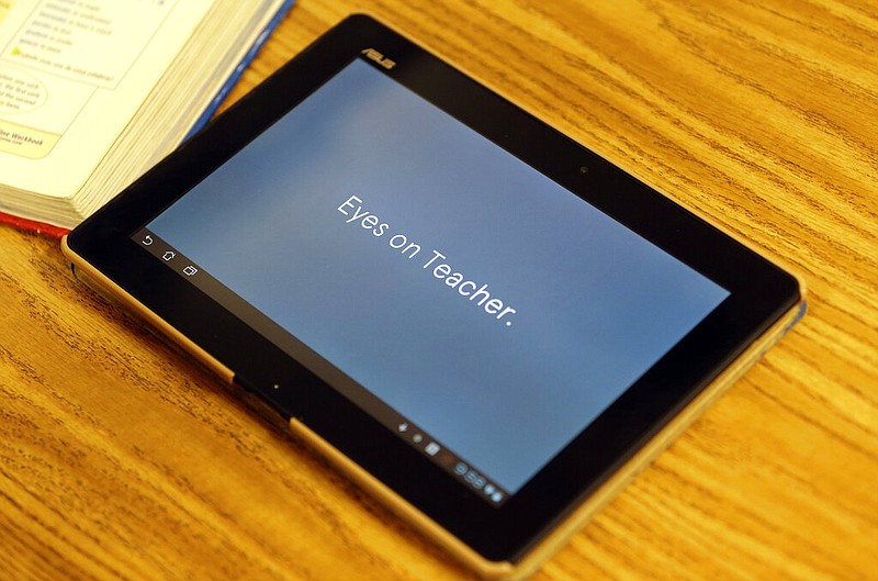 Students are instructed via tablet to direct their attention to the teacher during an eighth grade Spanish class at Autrey Mill Middle School in Johns Creek, Ga. on Thursday, May 9, 2013. (AP Photo/John Bazemore)