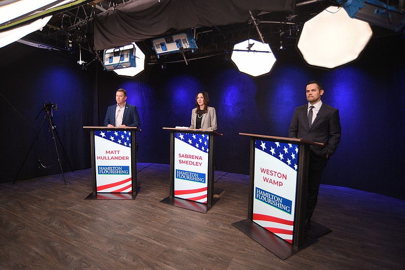 Staff Photo by Matt Hamilton / Candidates, from left, Matt Hullander, Sabrena Smedley and Weston Wamp stand behind their podiums before the start of the Hamilton County Mayoral Republican Primary Debate on Monday, February 21, 2022 at SociallyU Studio. 