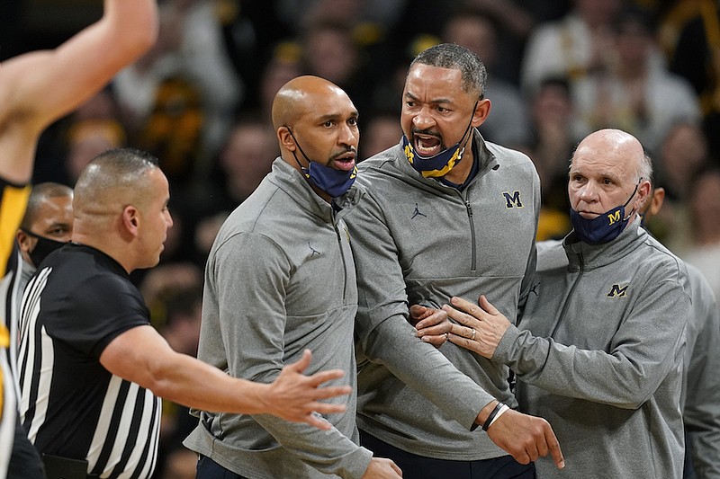 Michigan head coach Juwan Howard, center, reacts after being called for a technical foul during the first half of an NCAA college basketball game against Iowa, Thursday, Feb. 17, 2022, in Iowa City, Iowa. (AP Photo/Charlie Neibergall)