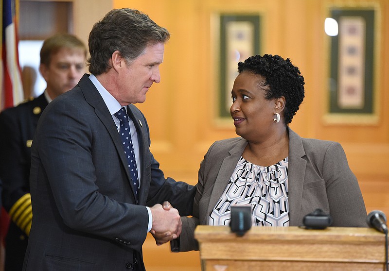 Chattanooga Mayor Tim Kelly (left) shakes the hand of Chattanooga's new police chief, Celeste Murphy(right), at a press conference Tuesday announcing her new role. The deputy chief for the Atlanta Police Department will be the first woman, and the first Black woman, to head the department. 