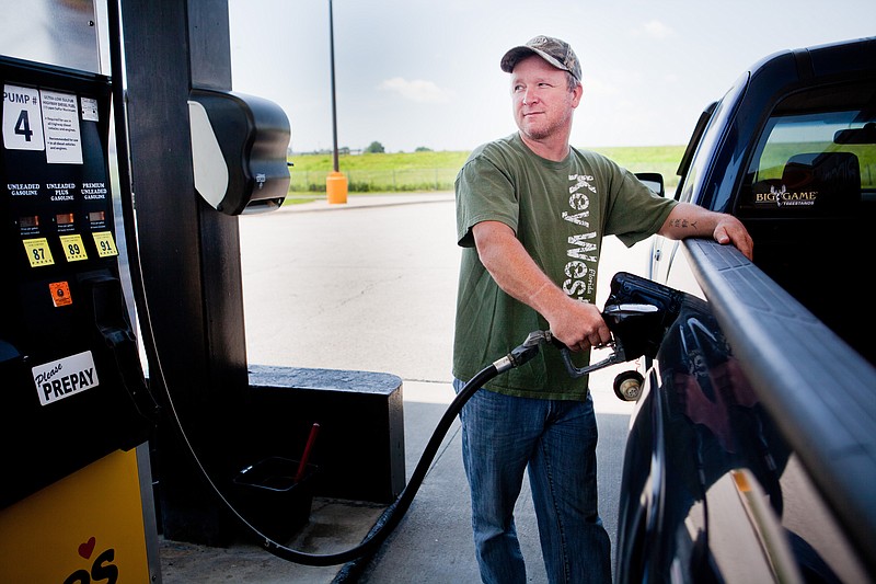 In 2014, Lance Thompson pumps gas into his truck at a Love's station in St. Joseph, Mo. (AP Photo/St. Joseph News-Press, Sait Serkan Gurbuz)