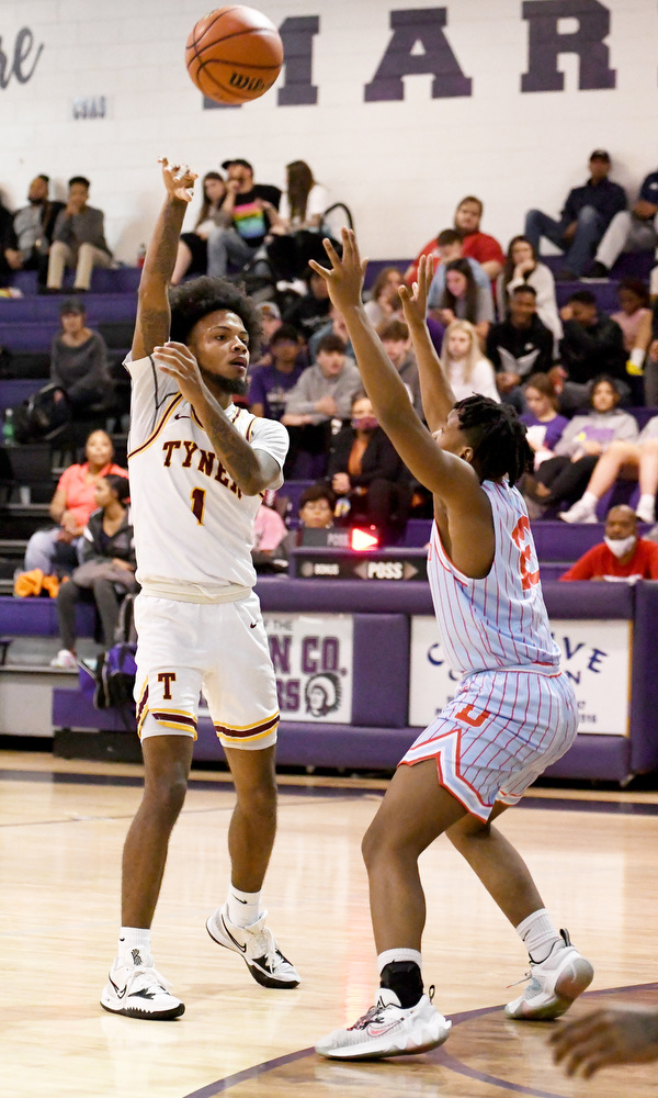 Staff Photo by Robin Rudd / Tyner's Xavier Fisher (1) passes over a Panther defender. The Tyner Rams met the Brainerd Panthers in the District 4-AA tournament championship, at Marion County High School in Jasper, on February 22, 2022.