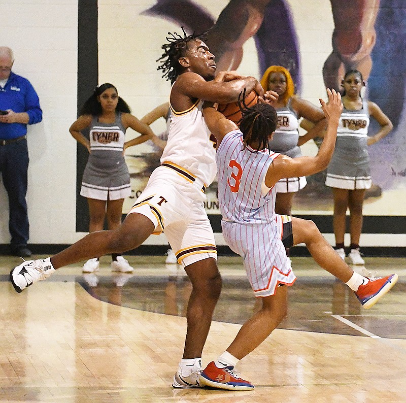 Staff Photo by Robin Rudd / Tyner's Nehemiah Bloodsaw (4) and Brainerd's Dennis Lewis Jr. (3) battle for the ball in the backcourt.  The Tyner Rams met the Brainerd Panthers in the District 4-AA tournament championship, at Marion County High School in Jasper, on February 22, 2022.