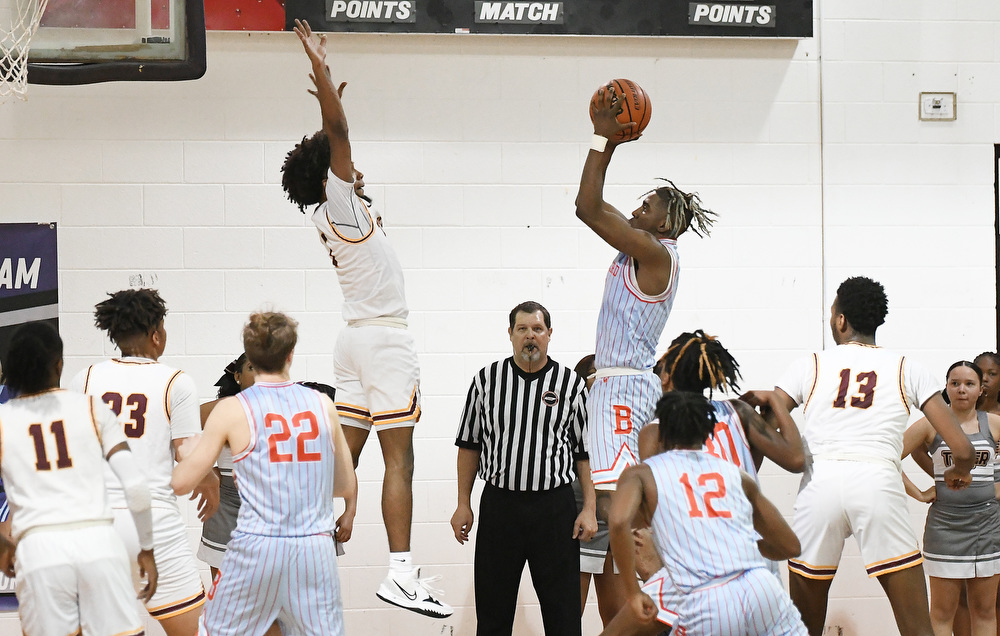 Staff Photo by Robin Rudd / Brainerd's Jakyse Locklin (4) shoots over Tyner's Xavier Fisher (1). The Tyner Rams met the Brainerd Panthers in the District 4-AA tournament championship, at Marion County High School in Jasper, on February 22, 2022.