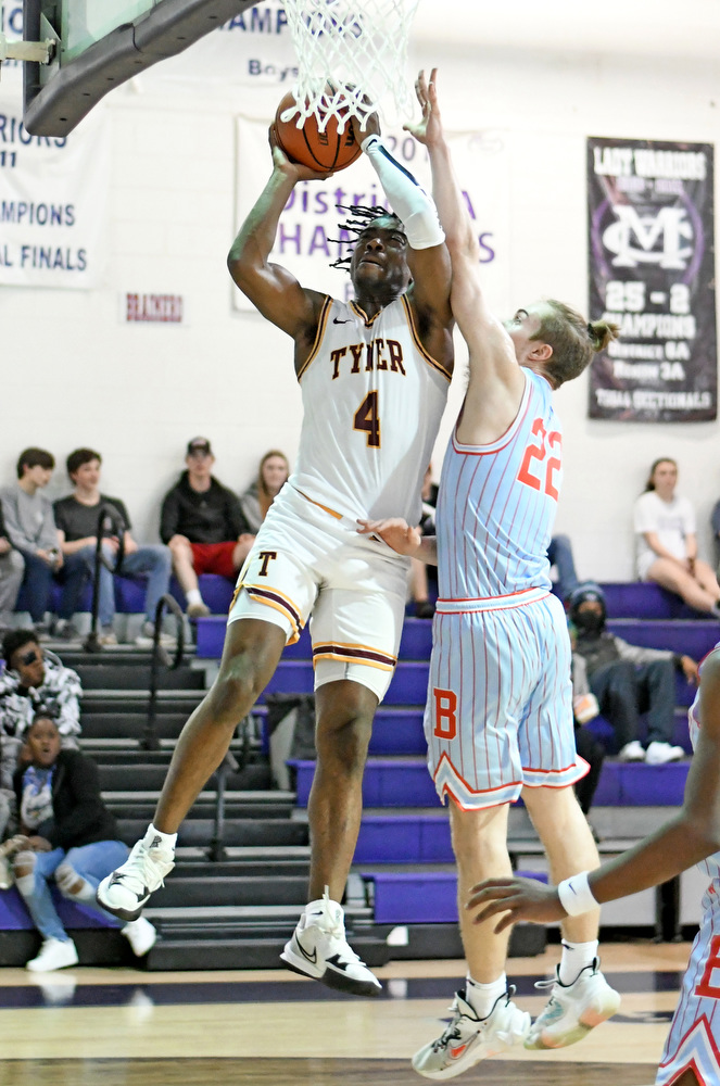 Staff Photo by Robin Rudd / Tyner's Nehemiah Bloodsaw (4) scores against Brainerd's Joshua Hood (22). The Tyner Rams met the Brainerd Panthers in the District 4-AA tournament championship, at Marion County High School in Jasper, on February 22, 2022.