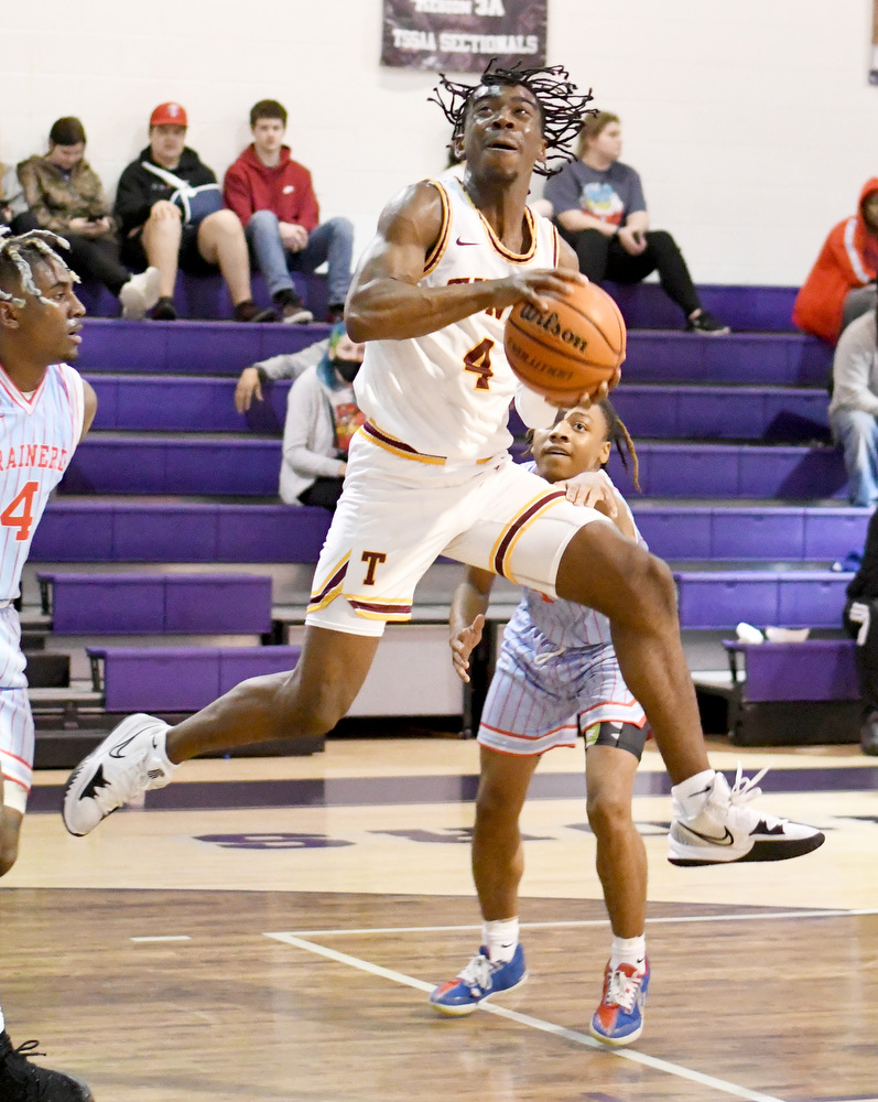 Staff Photo by Robin Rudd / Tyner's Nehemiah Bloodsaw (4) drives between two Panther defenders and scores on a off-balance shot. The Tyner Rams met the Brainerd Panthers in the District 4-AA tournament championship, at Marion County High School in Jasper, on February 22, 2022.