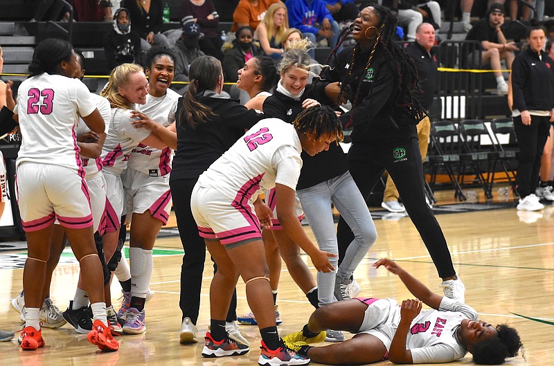 Staff photo by Patrick MacCoon / East Hamilton celebrates after a 50-38 victory at home over Signal Mountain in the District 6-AAA championship game Tuesday night.
