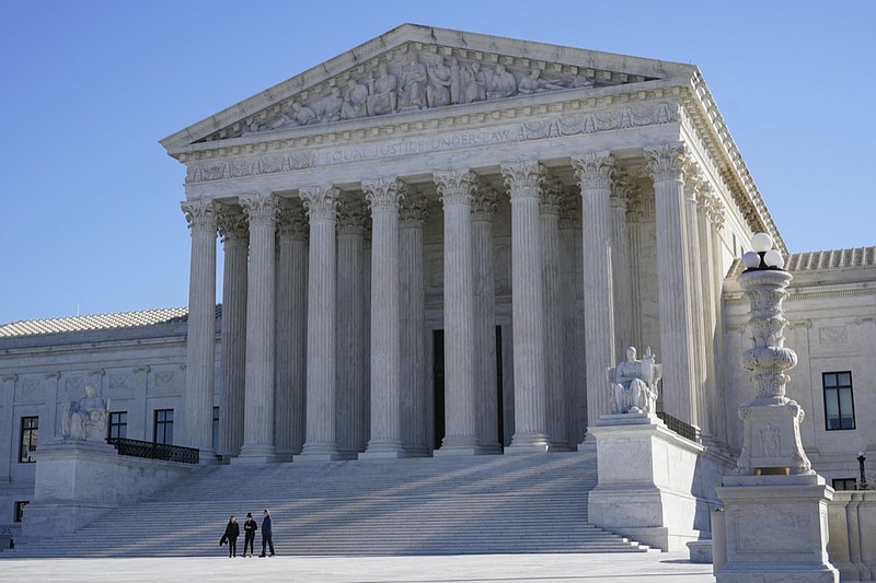 Visitors walk outside the Supreme Court building on Capitol Hill in Washington, Monday, Feb. 21, 2022. (AP Photo/Patrick Semansky)